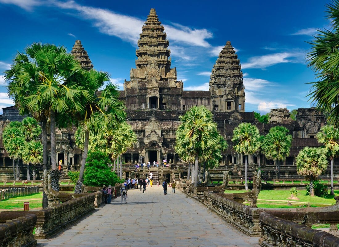 Tourists walking into Angkor Wat main entrance in Cambodia