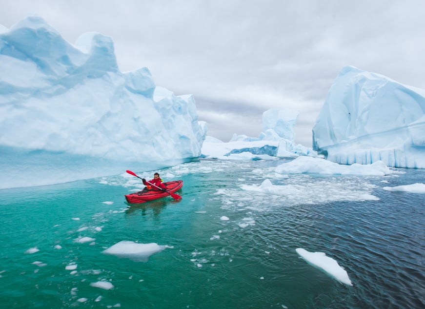 A_Man_In_A_Kayak_Icebergs_Shutterstock_CCSong_about_summer_ulxhgp-1