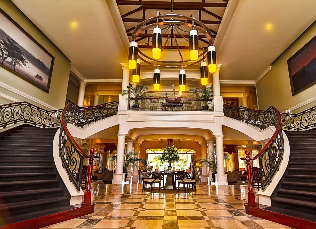 The entrance hall to the hotel opens upto a two-way staircase. The floors are marble and a large chandelier dangles over-head.