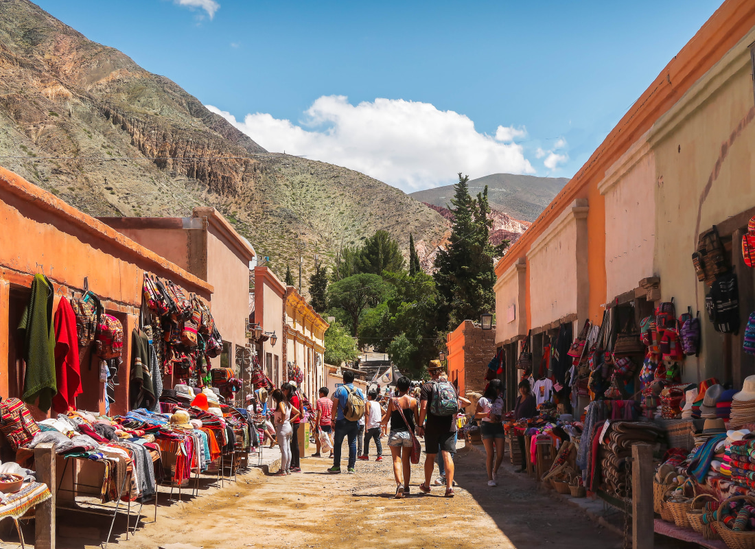 The streets at Purmamarca are lined with orange buildings that have colourful stalls selling local crafts. 