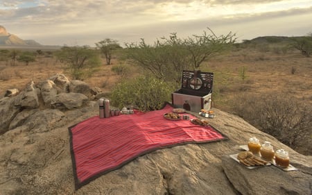 A picnic is laid out on a rock in Saruni Samburu.