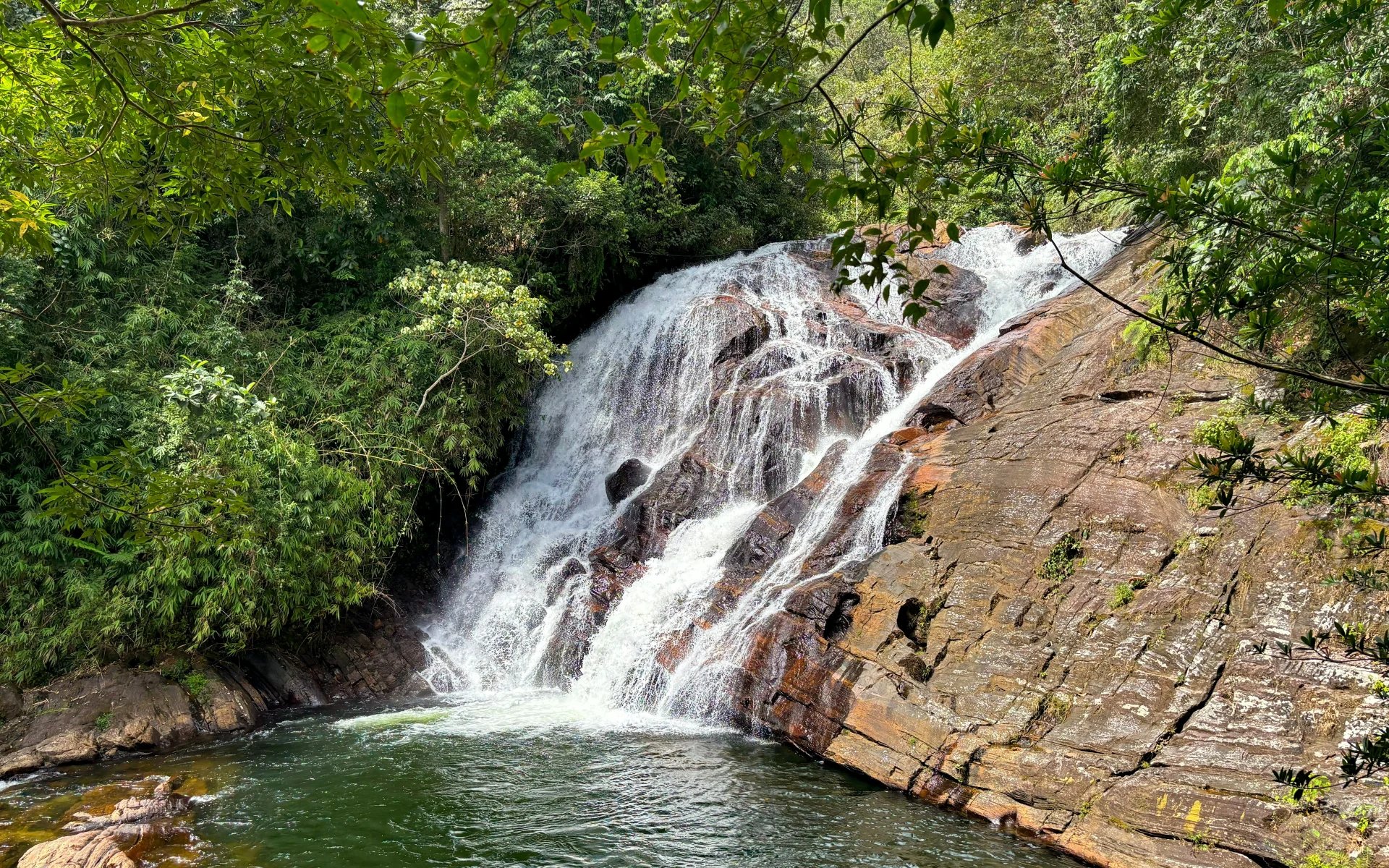  A gushing waterfall travels into a lake. 