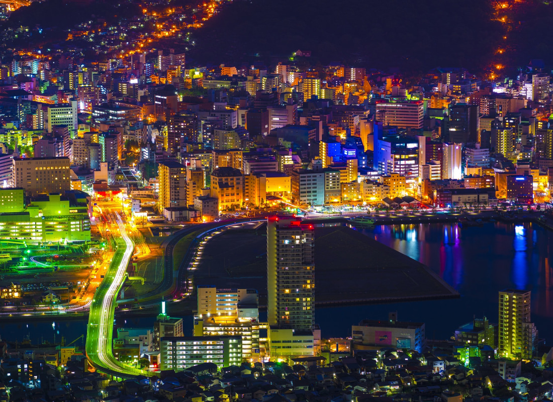 Nagasaki is lit up with lights at night. 