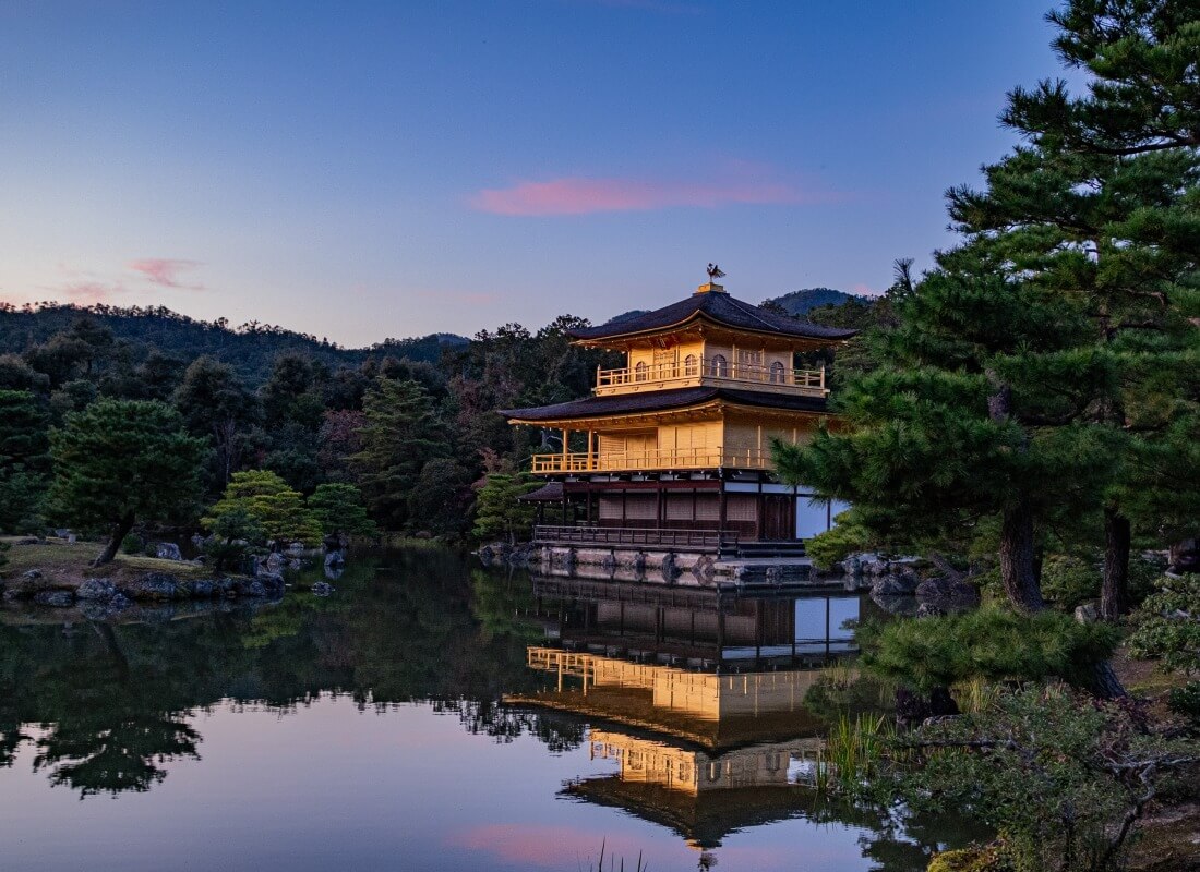 A palatial building overlooks the water in Kyoto.