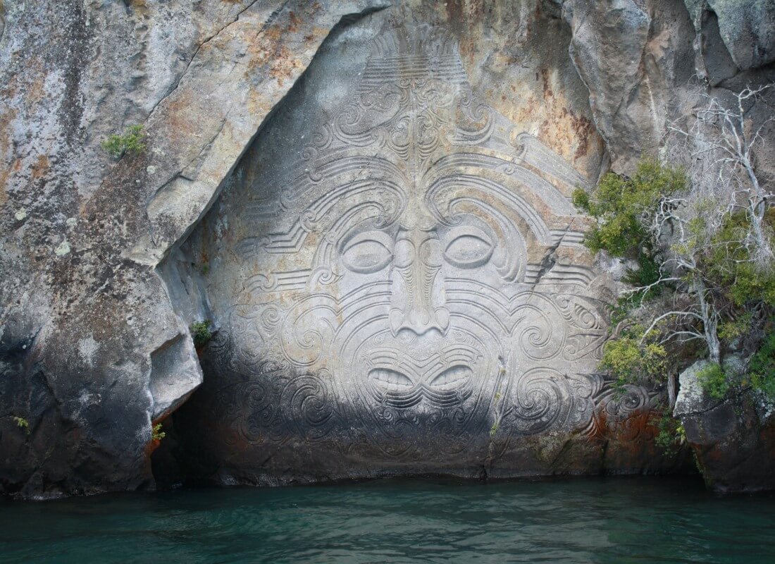 A monkey's face is etched into a rock.