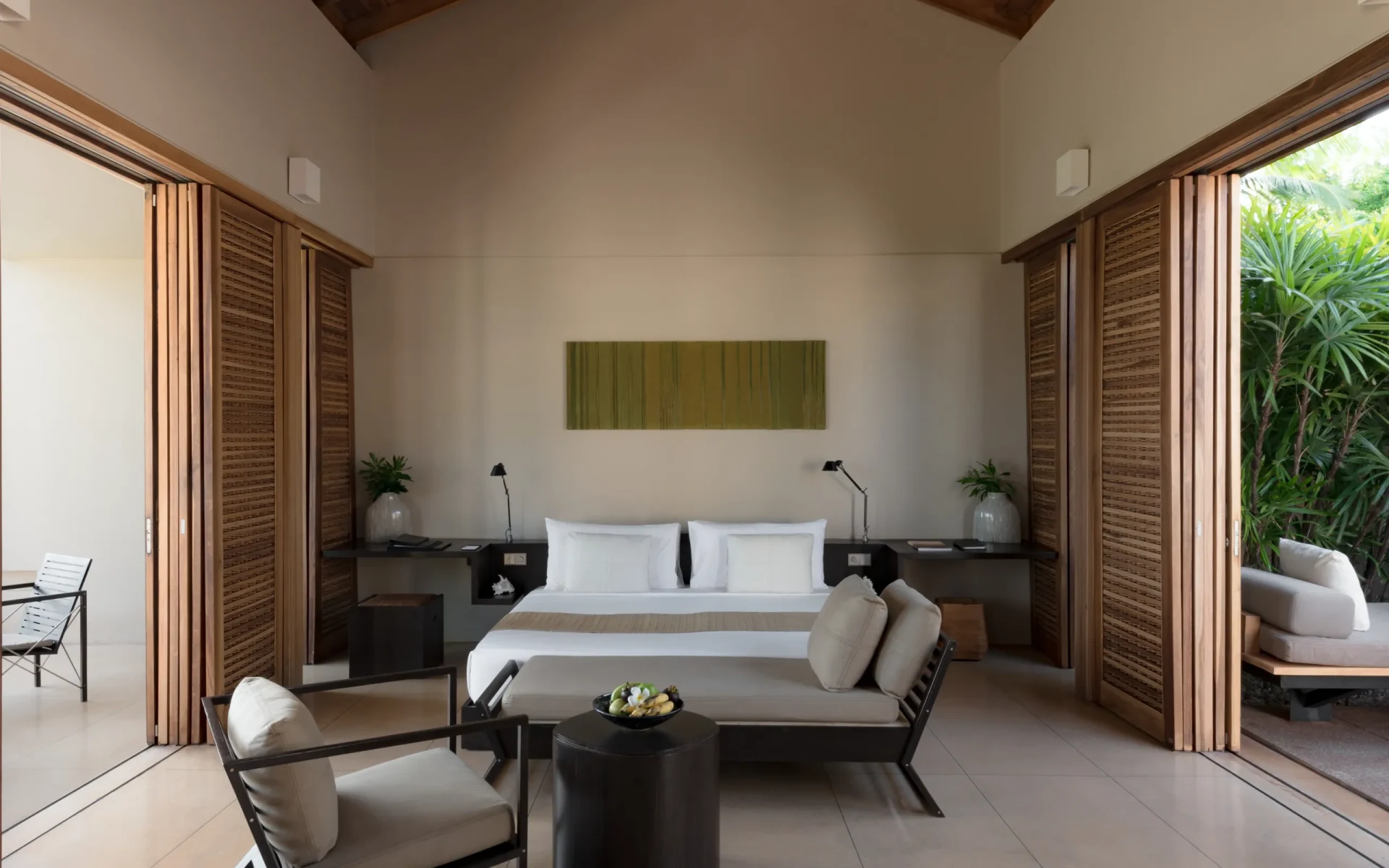 The bedrooms at Amanwella have floor-to-ceiling wooden shutters that open to the pool and garden.
