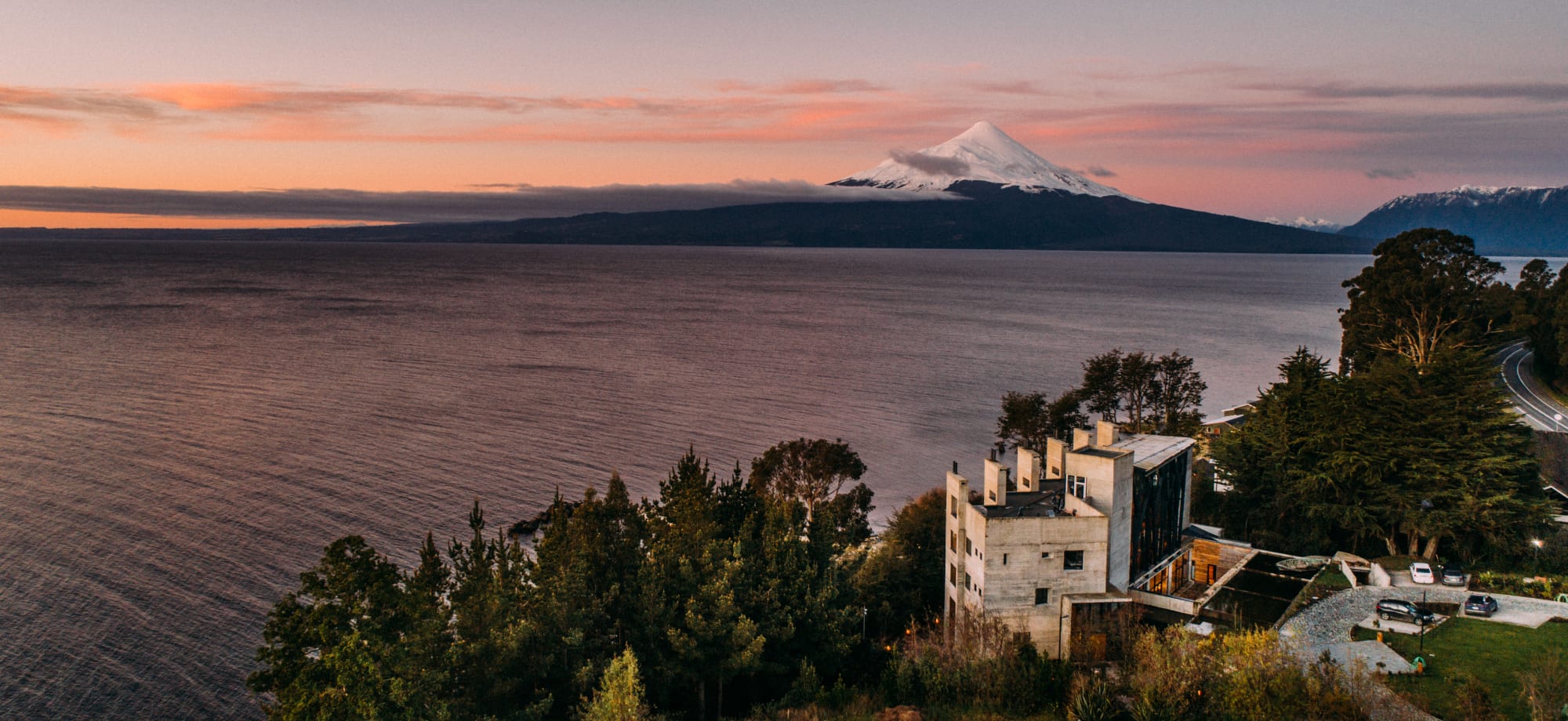 Hotel AWA overlooks the river with snowy, white mountains in the far distance. 