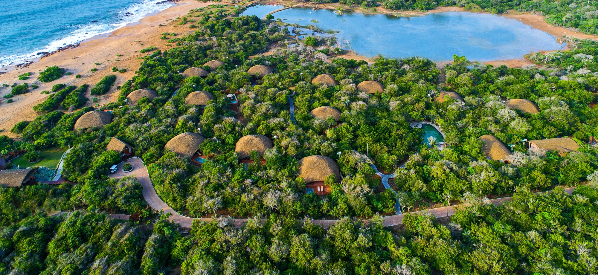 Chena Huts is comprised of thatched cottages surrounded by greenery and the ocean. 