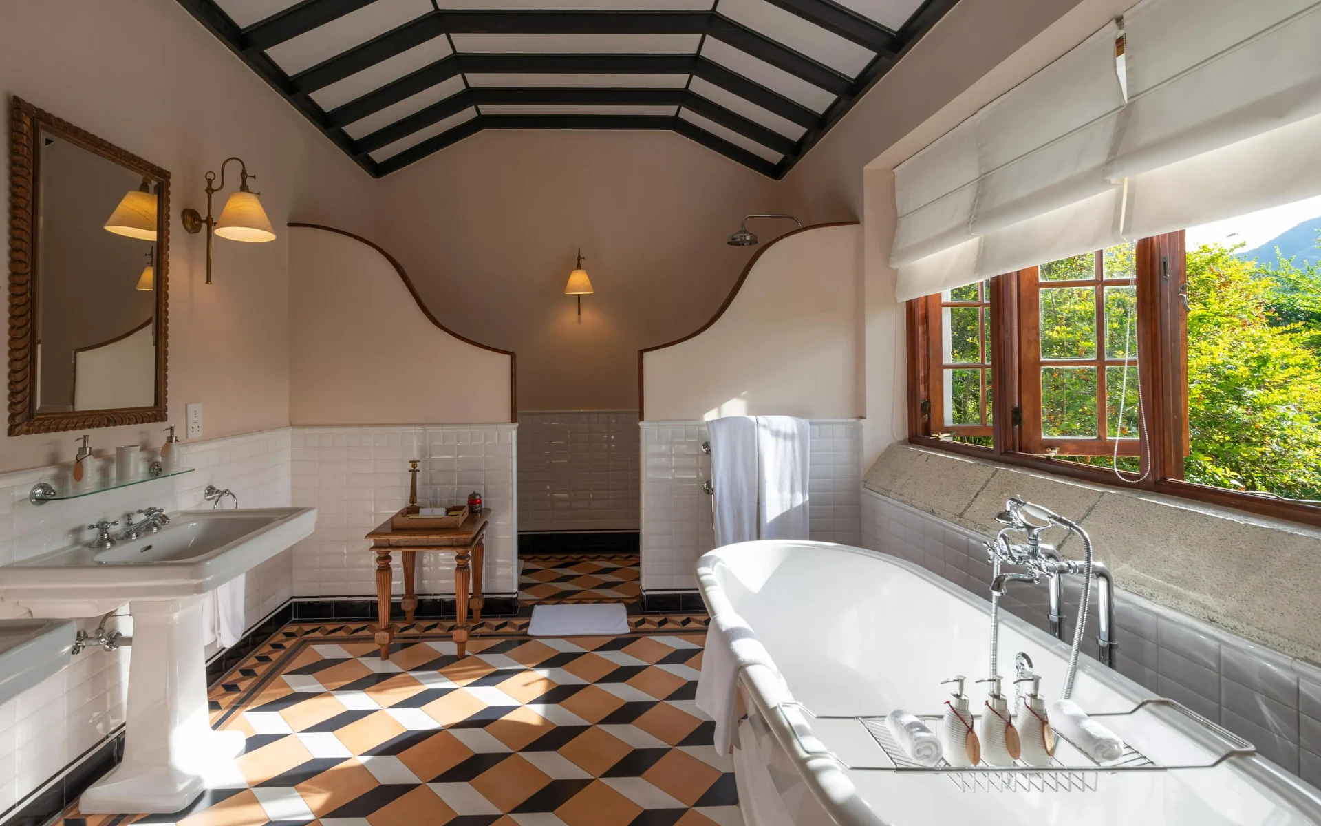 A bathroom at the Ceylon Tea Trails, dressed in colourful tiles and equipped with a free-standing bathtub.