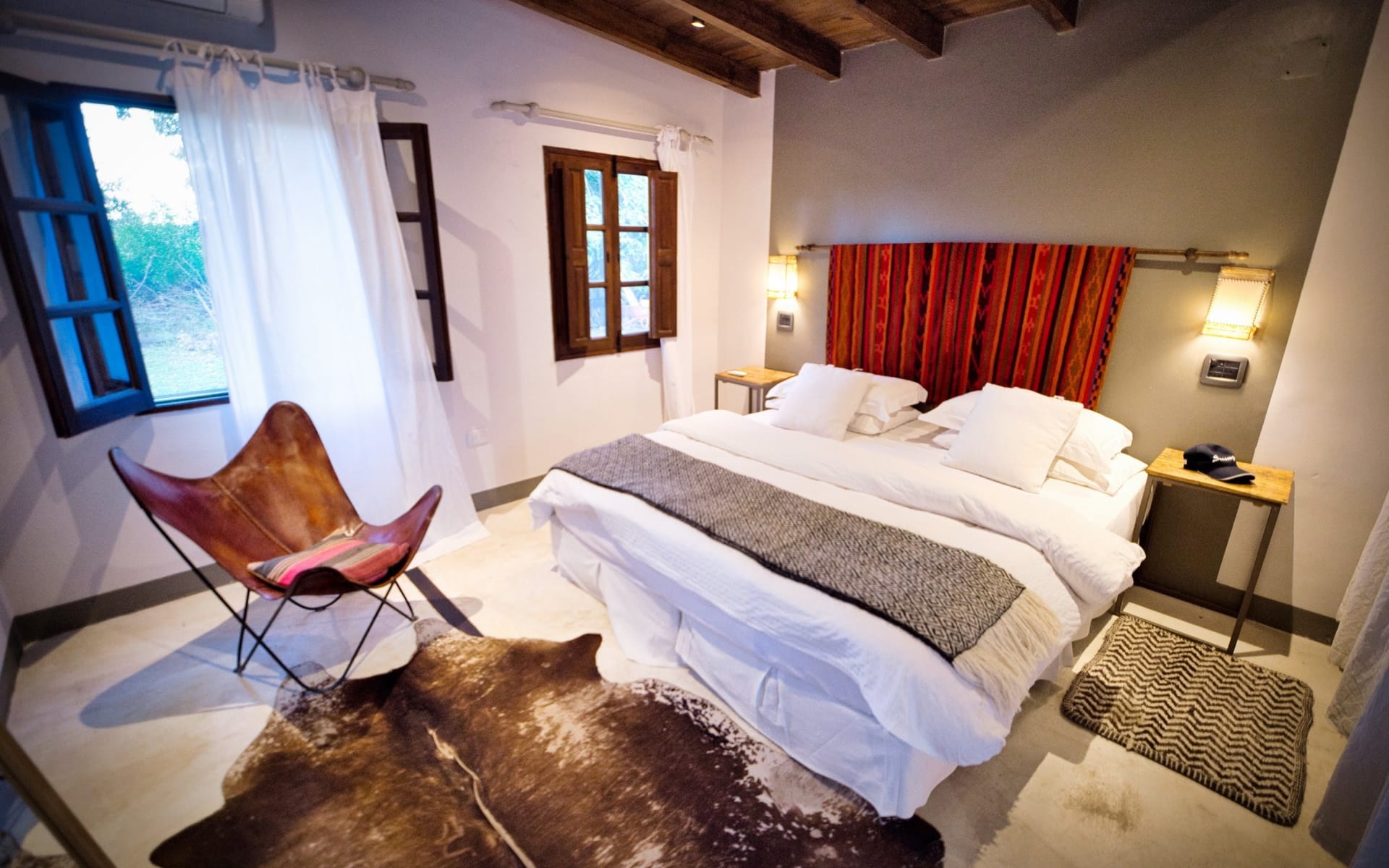 The rooms at Finca-Valentina are designed with a down-to-earth theme, with animal skin rugs, red tapestries, leather seats and low hanging lights.