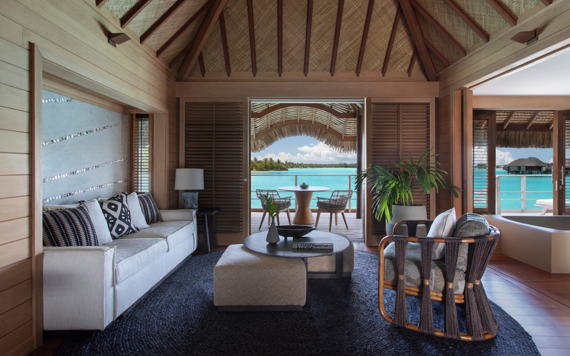 Overwater bungalow living area with ocean views