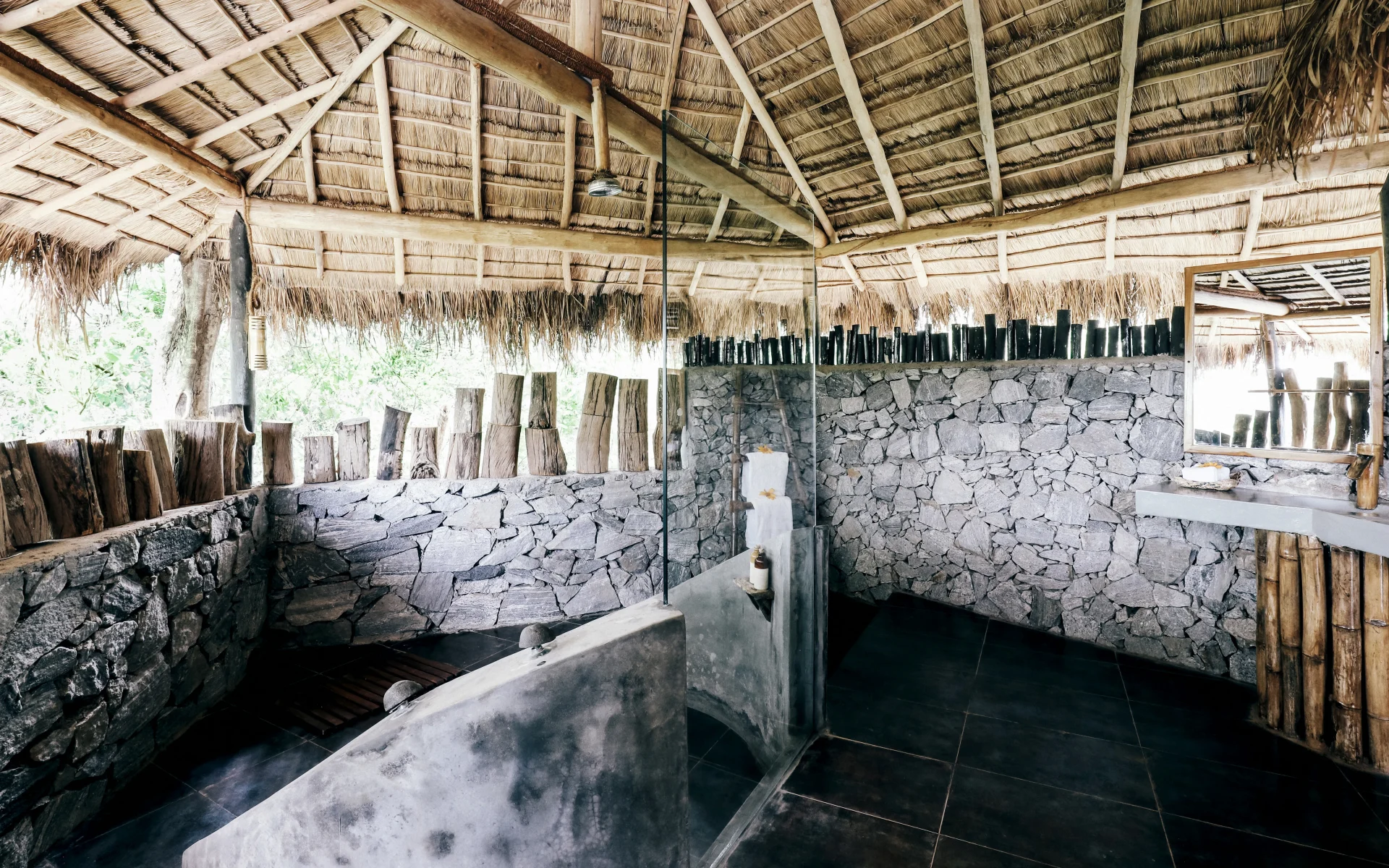 The bathrooms at the lodge have tiled floors and stone walls, equipped with huge walk-in showers.