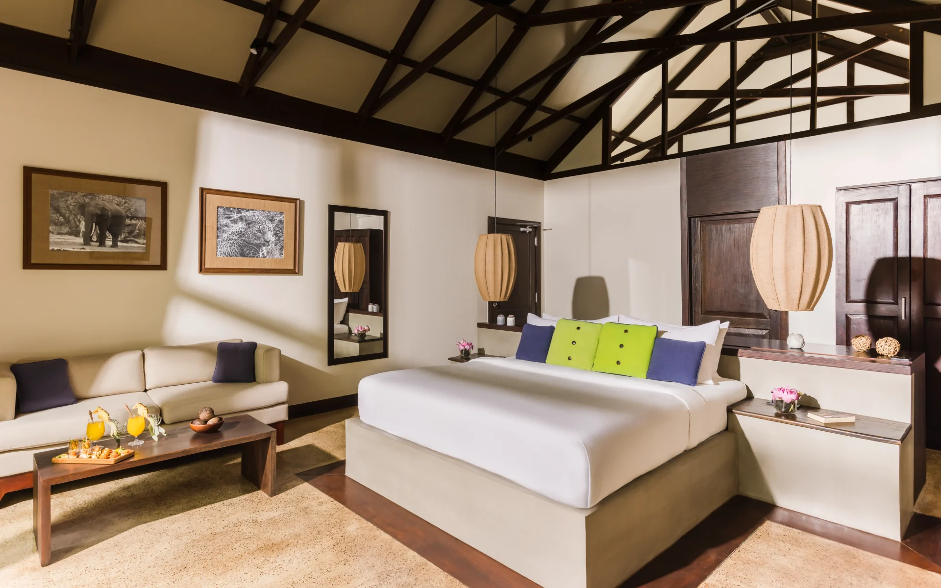 Cabin bedrooms at Jungle Beach are modern and dressed in a neutral colour palette, with high-beamed ceilings.