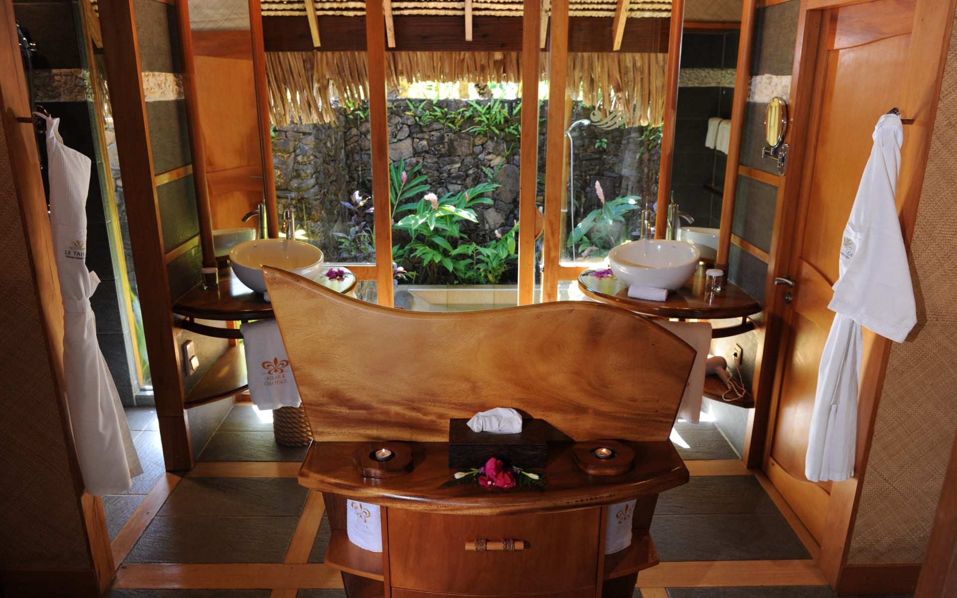Luxurious Jack and Jill bathroom with door out to the beautiful nature of Tahaa