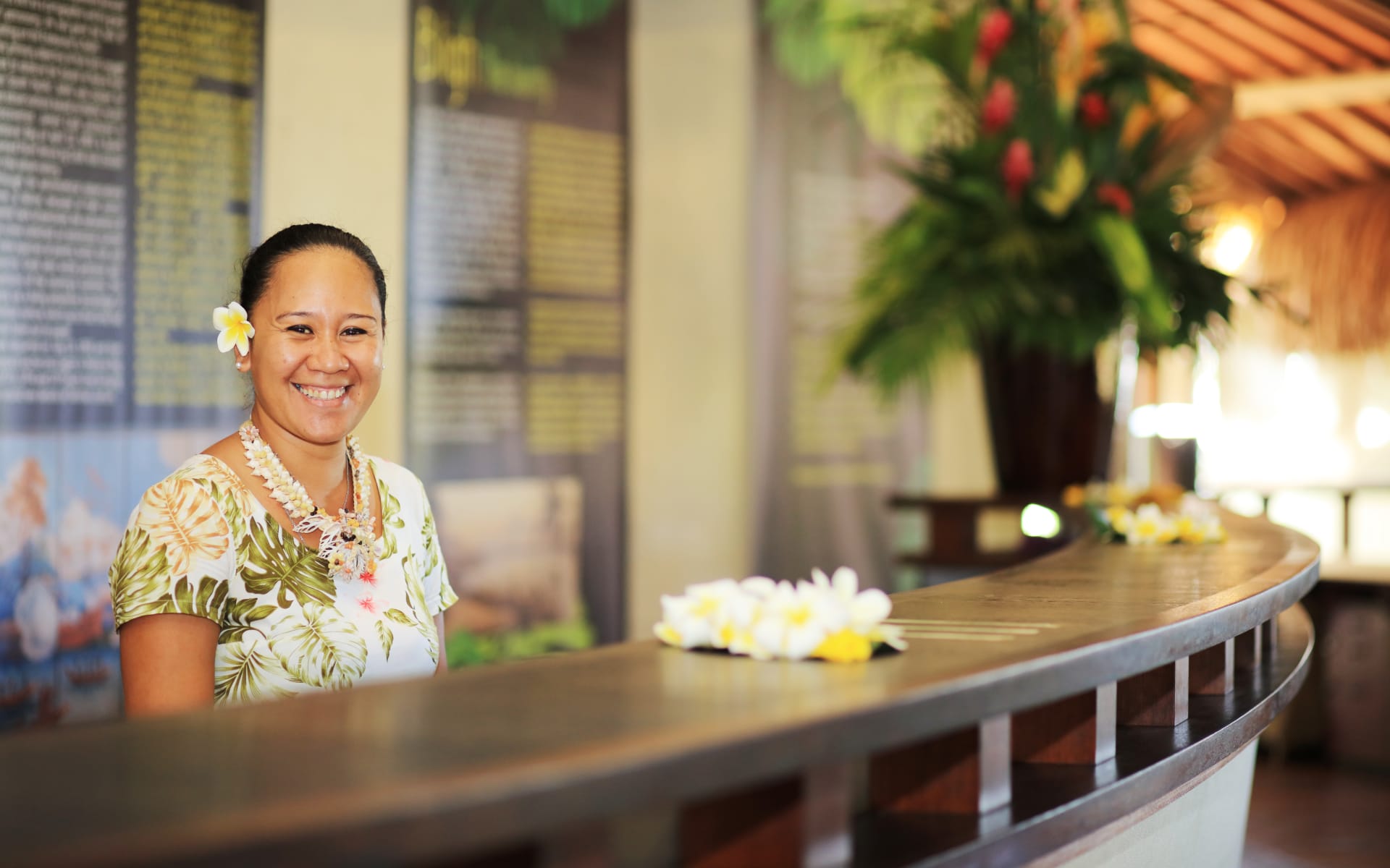 Lady at reception providing guests with a warm smile