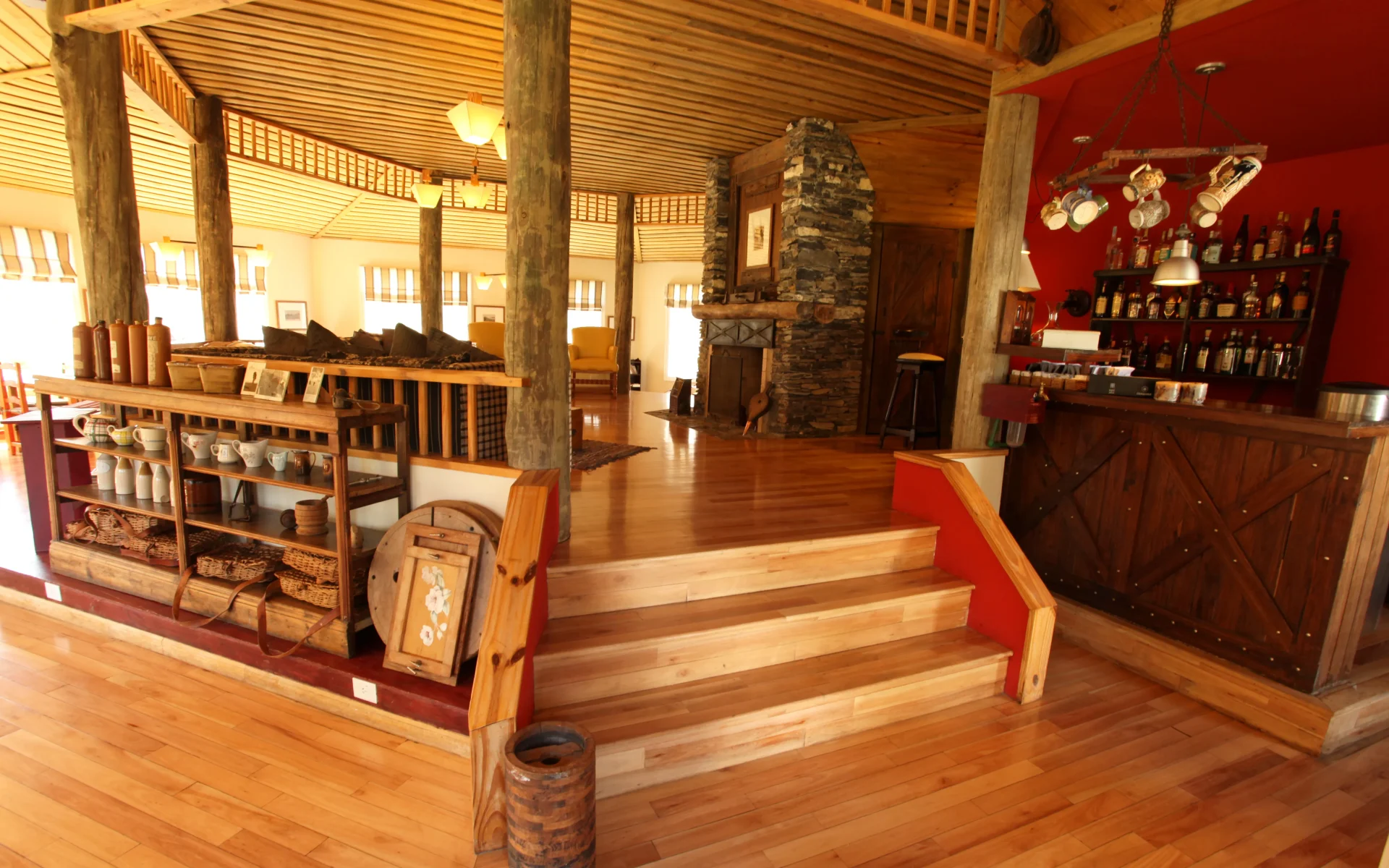 The interior of the main estancia is adorned in glossy wood panelling and there is a stone fireplace in the centre.
