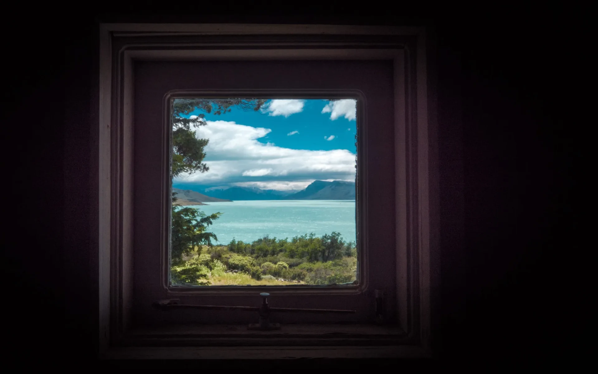 The bathroom window in the estancia looks out at a mesmerising view of Lake Argentino and the tumbling mountains behind it.