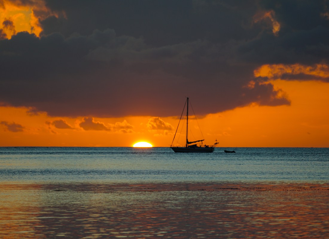 Exceptional sundown with beautiful colours and boats in Raiatea Island, French Polynesia. 