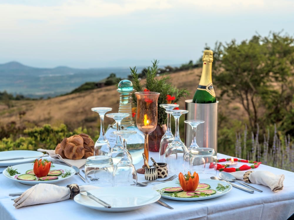 A white table with champagne, food and excellent views 