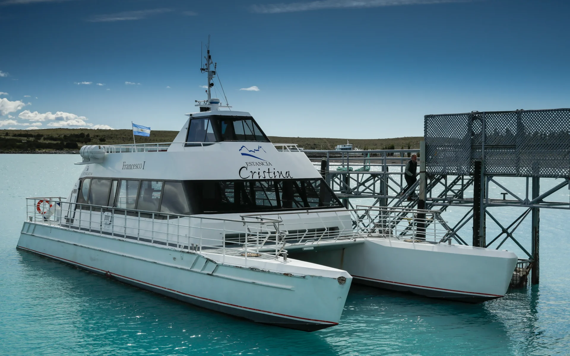 Estancia Cristina's catamaran is sleek and white, waiting on Lago Argentino to take guests on trip.
