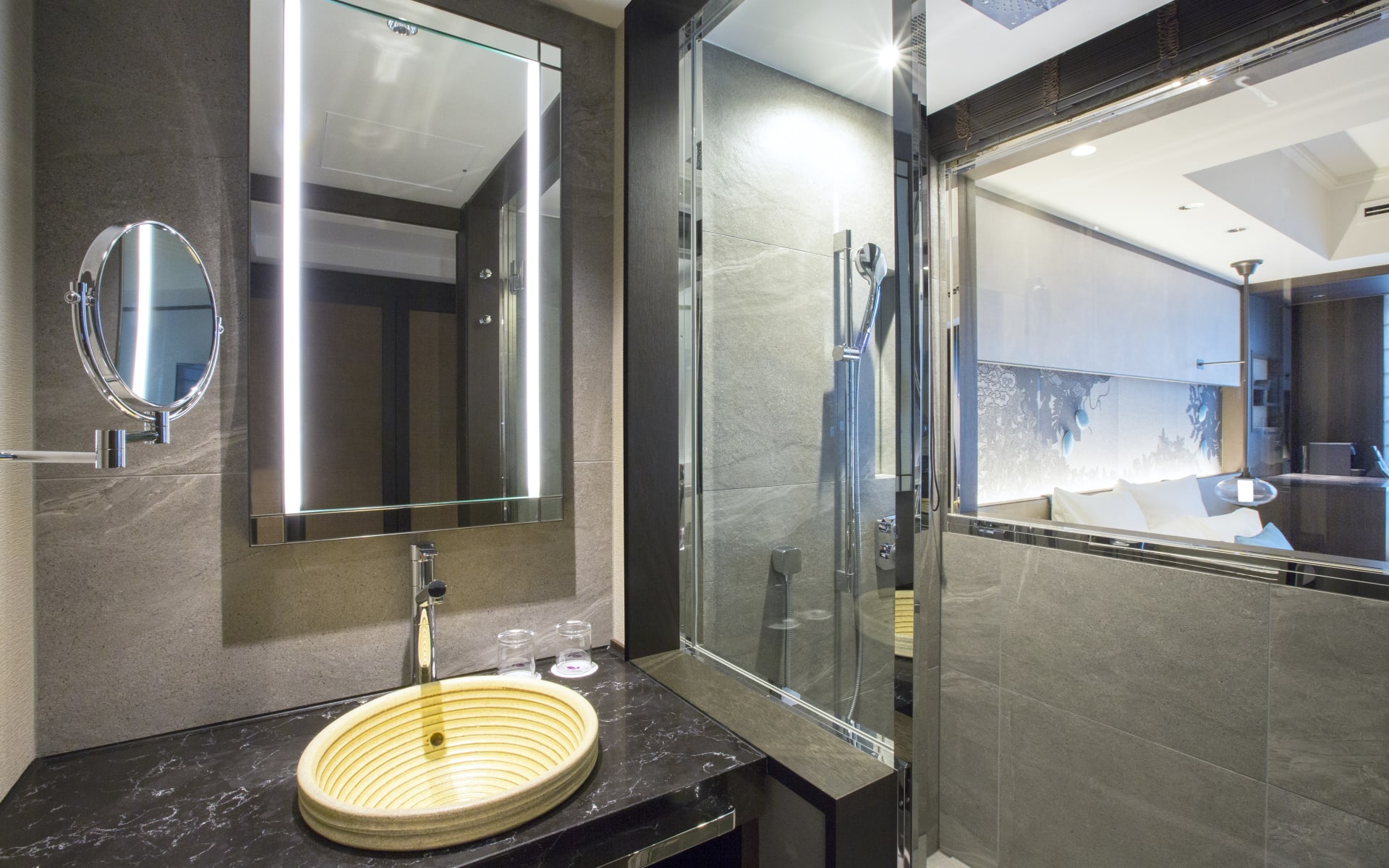 The bathroom at Dhawa Yura has a large mirror, sink and walk-in shower. 