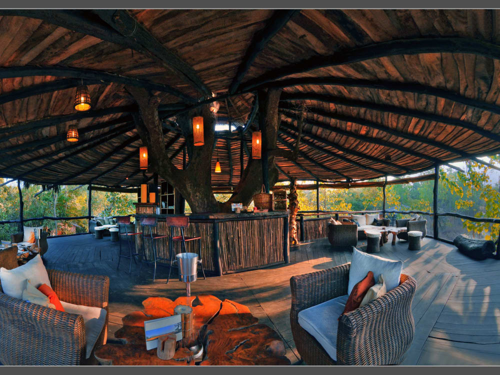 The treehouse's bar with armchairs and lantern lights