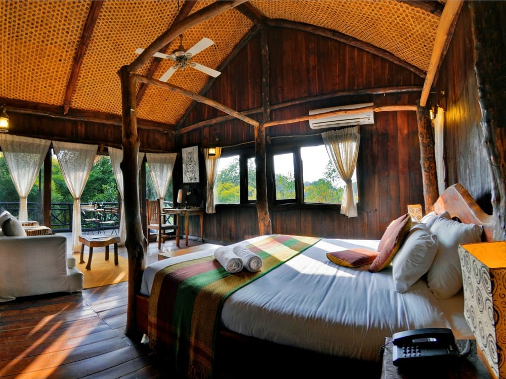 A canopy bed overlooking a living room
