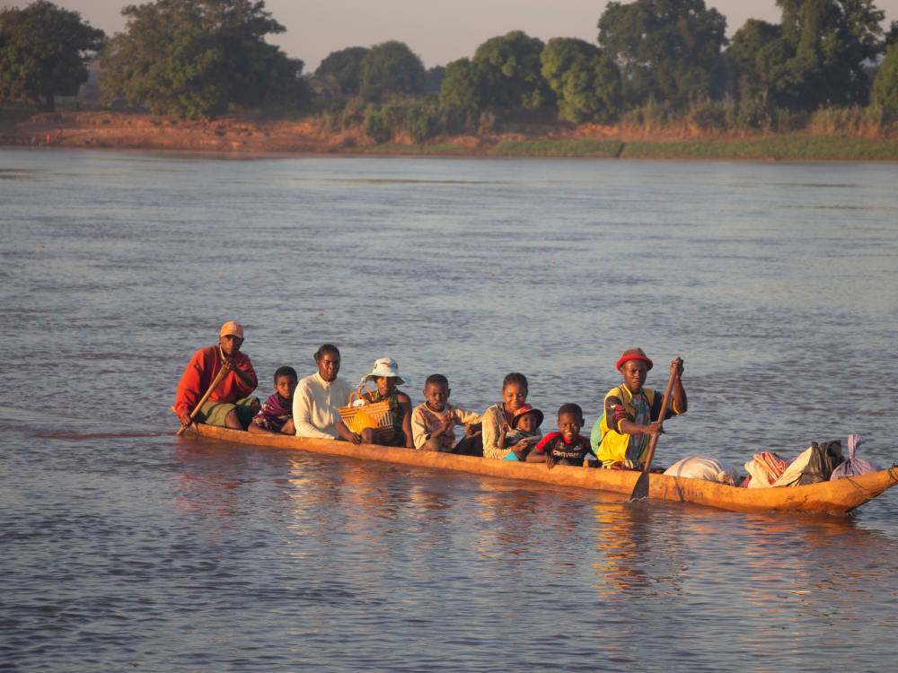 A boat full of people in the middle of a river