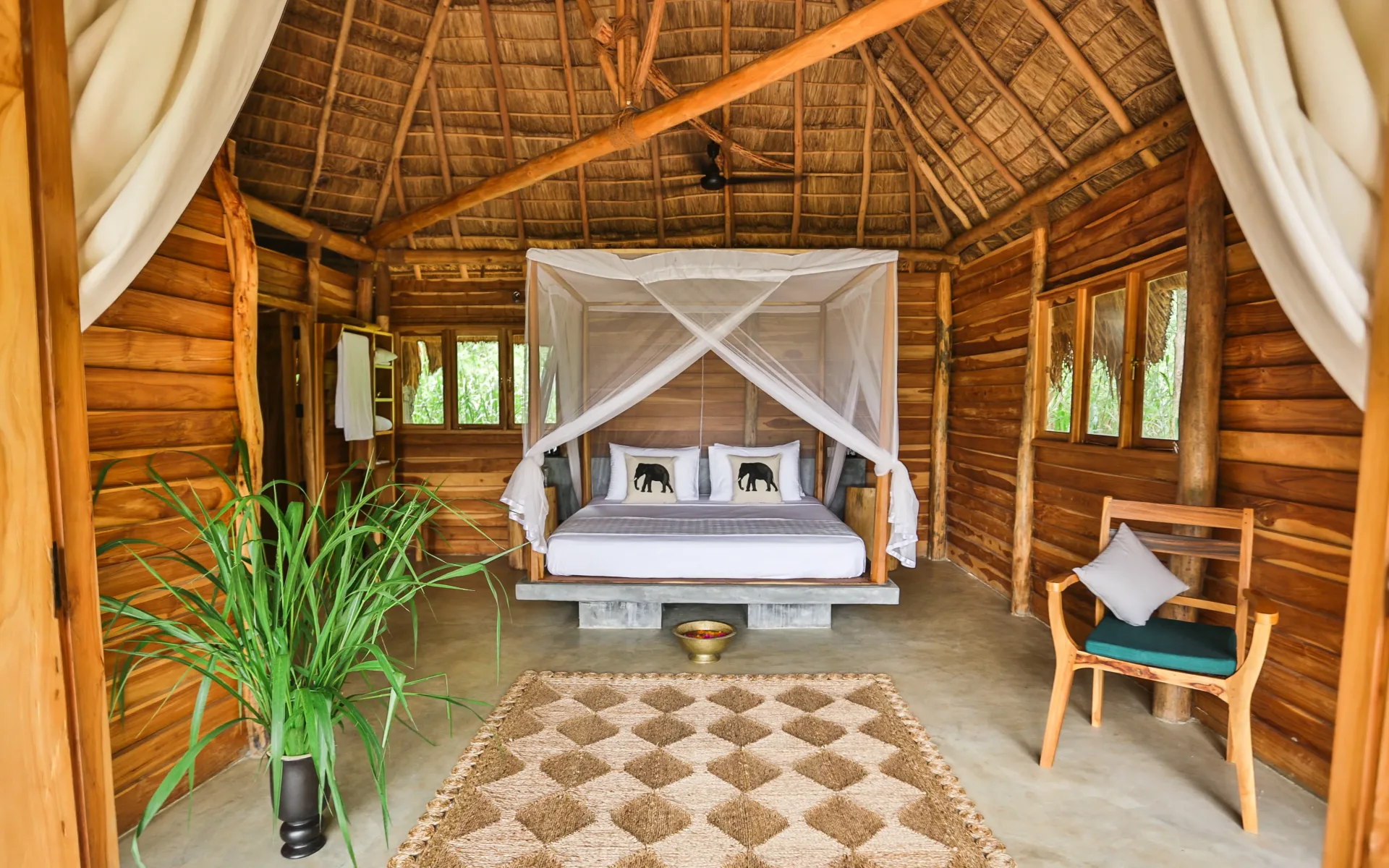 The bungalows at Gal Oya Lodge are adorned in local hardwoods and decorated with traditional pieces, including a hand-woven rug.