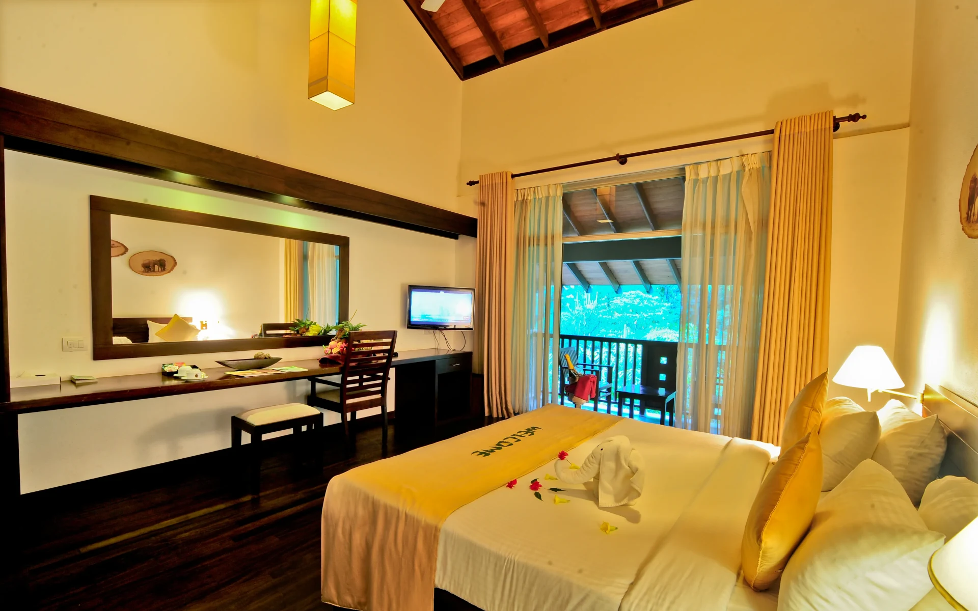 One of the Grand Deluxe Rooms at the resort. It is spacious and modern, opening up onto a balcony. 