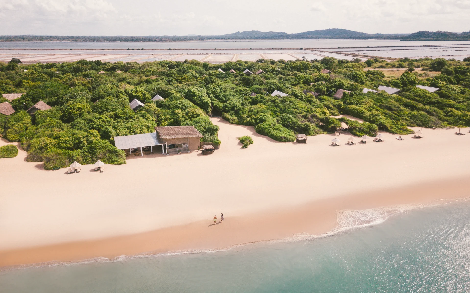 Uga Jungle Beach is fronted by a pristine, white-sanded beach, encased by emerald foliage. 