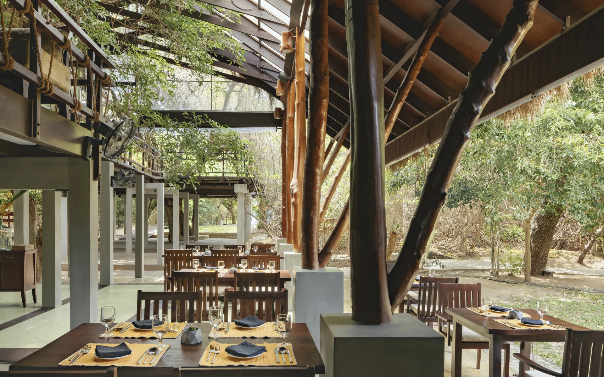 The Jungle Beach restaurant is open-air and adopts a rustic luxury style.