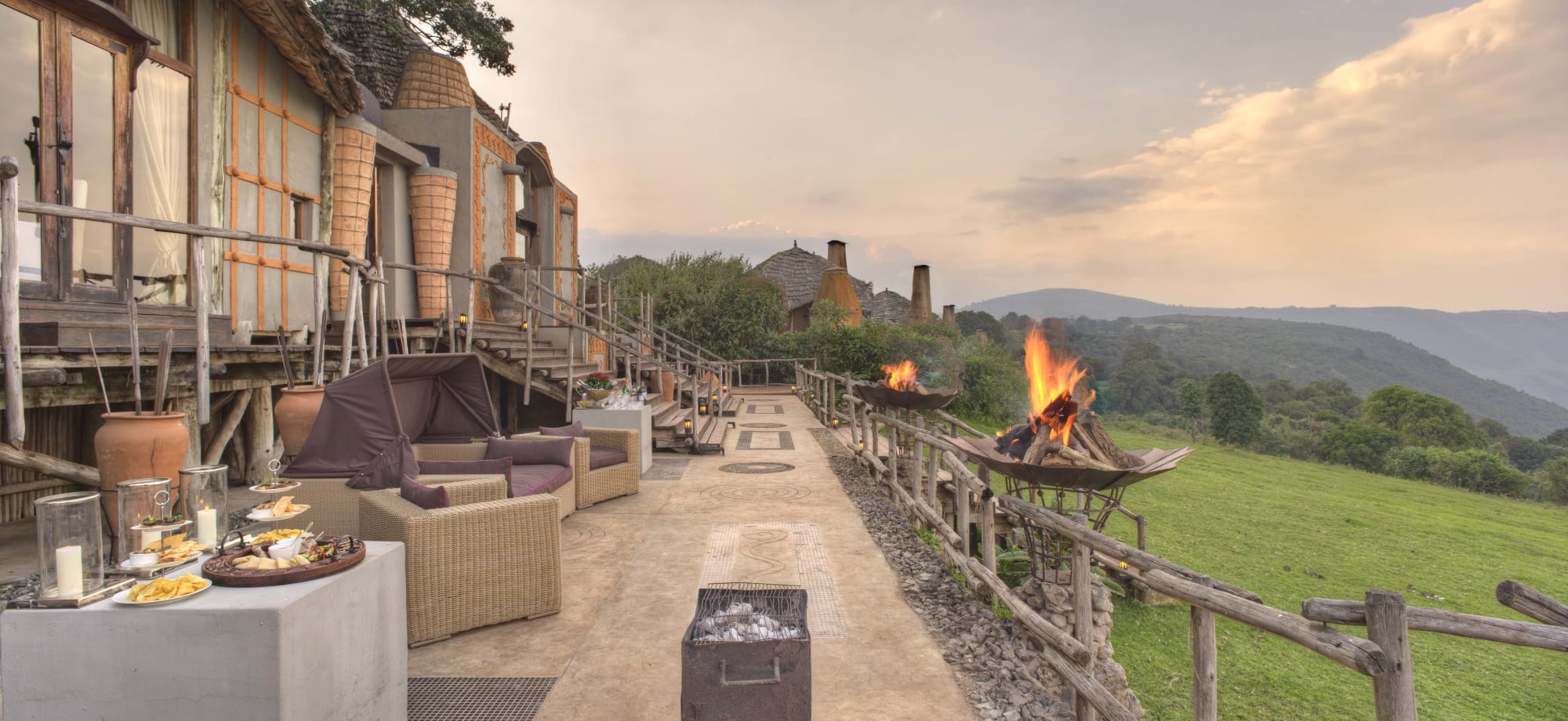 Crater Lodge's outdoor deck with fire pits and sofas