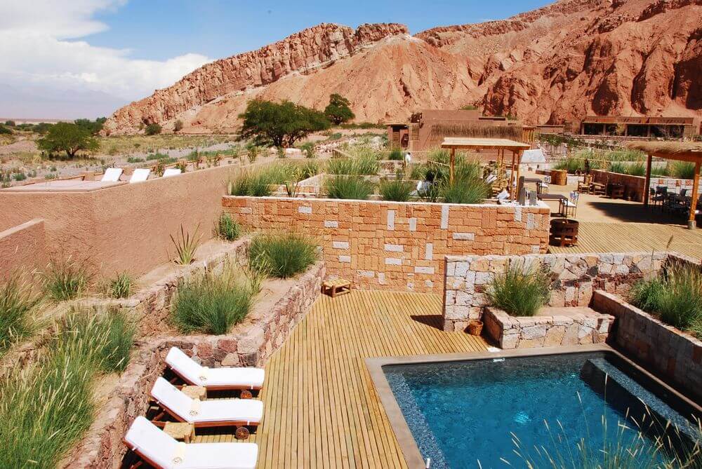 outdoor swimming pool surrounded by desert landscape at Alto Atacama, Chile