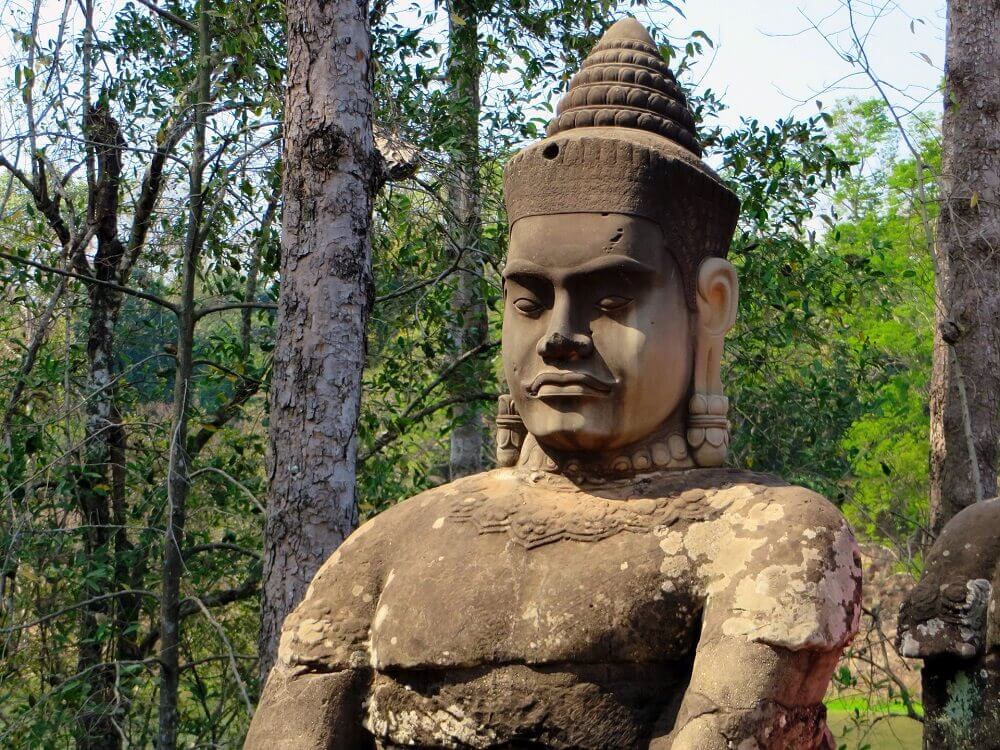 Angkor stone warrior statue in Angkor Cambodia