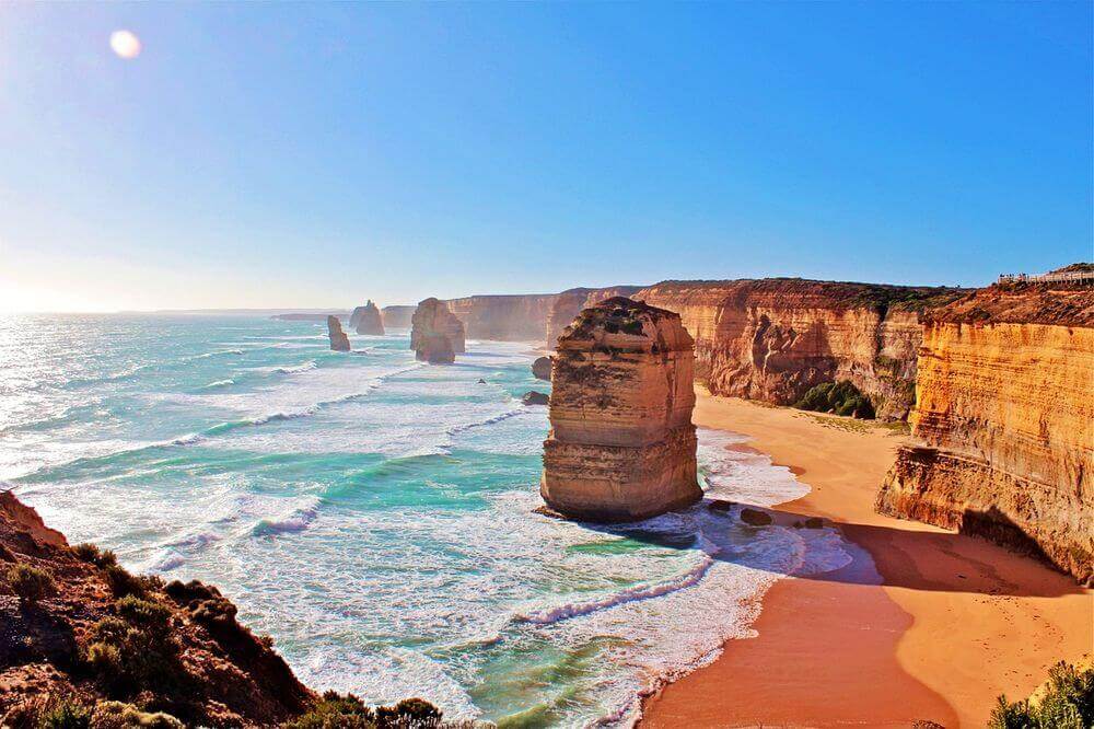 sunshine lighting up the orange rock of the twelve apostles in Vic