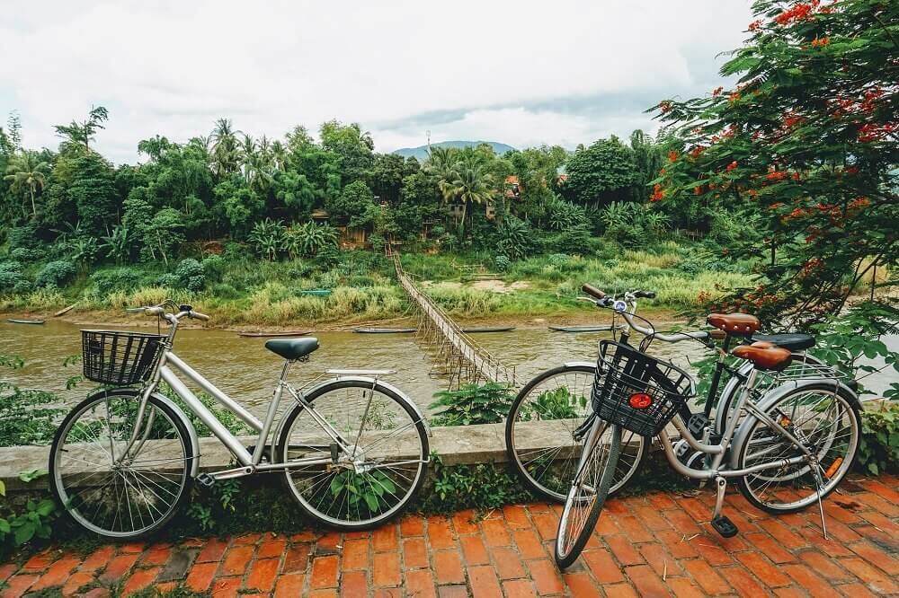 Bamboo bridge across Nam Khan river with bicycles in Luang Prabang Laos