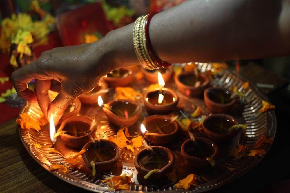candles being lit for diwali festival of lights india