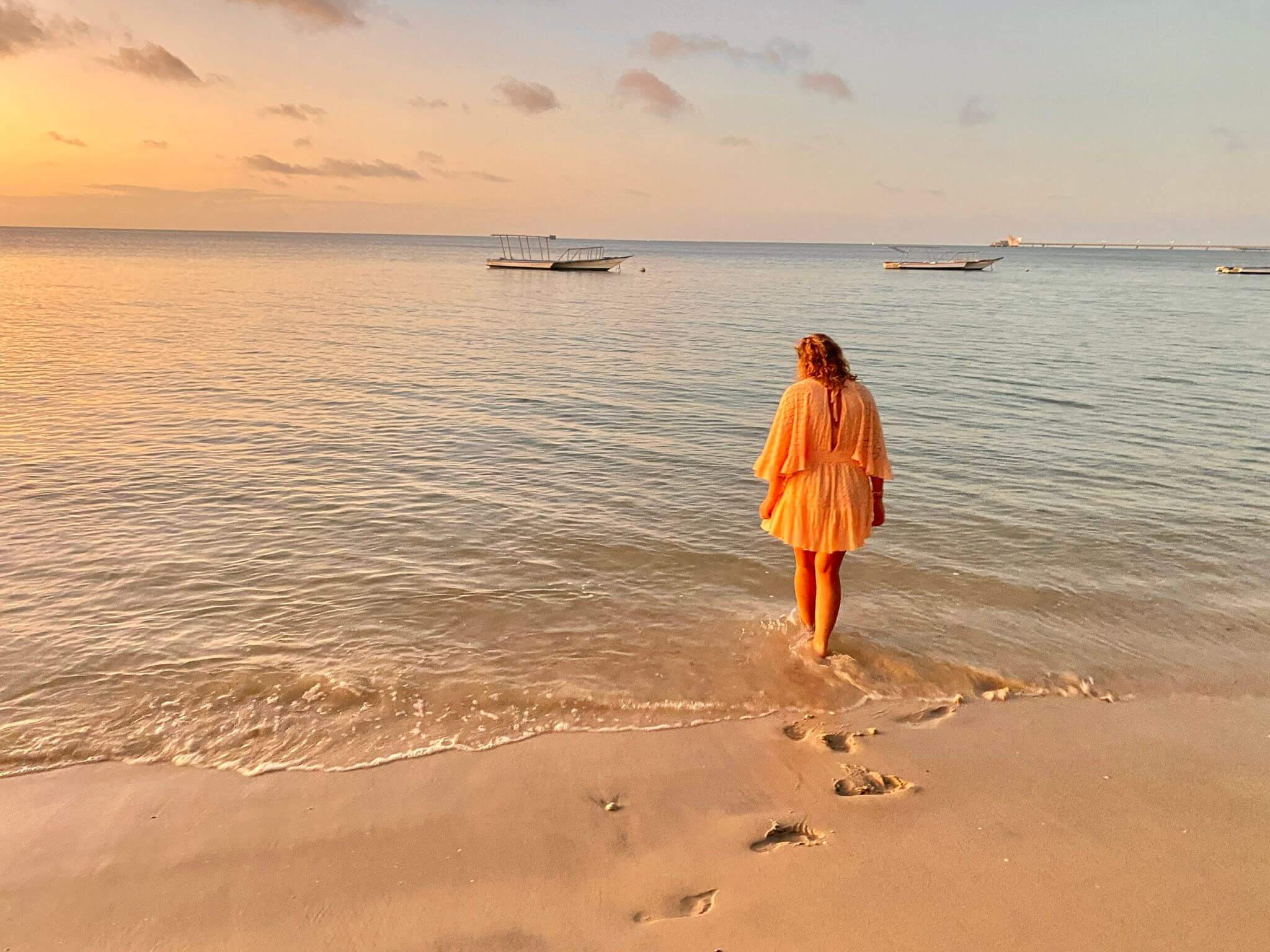 Yasmin enjoying a walk along the beach at sunset