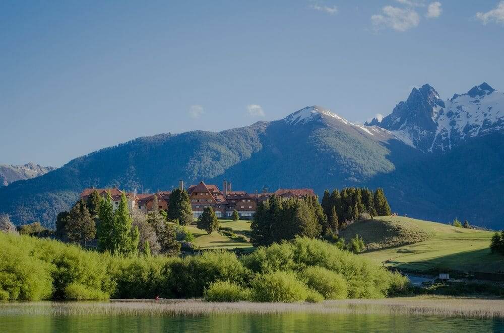 Llao Llao resort on the green lake shore with mountain backdrop bariloche argentina