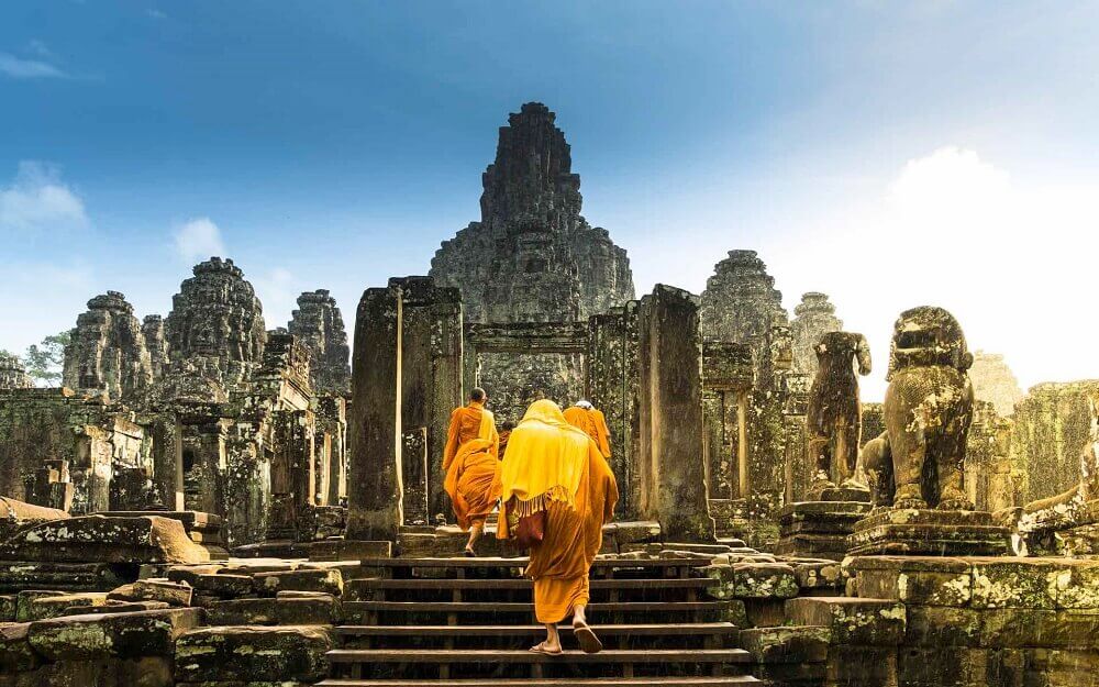 Monks in ancient Bayon temple in Angkor Cambodia