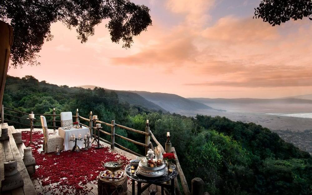 romantic sunset dinner with rose petals overlooking the might ngorongoro crater at ngorongoro crater lodge, tanzania