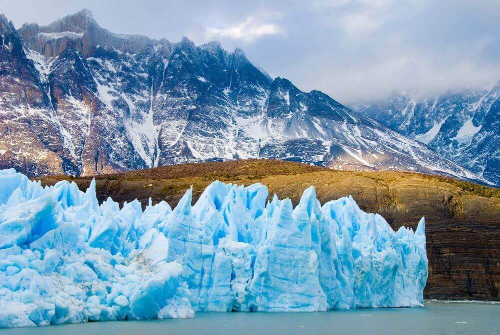 bright blue glaciers surrounded by snowy mountains in Patagonia, Chile