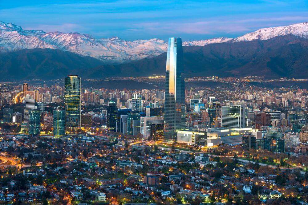 Aerial view of santiago city skyline with snow-capped mountains in the background