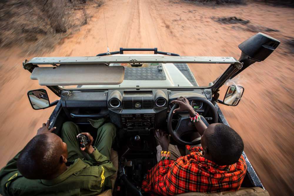 A Samburu guide and ranger lead the way on a rhino tracking experience at Saruni Rhino, Kenya