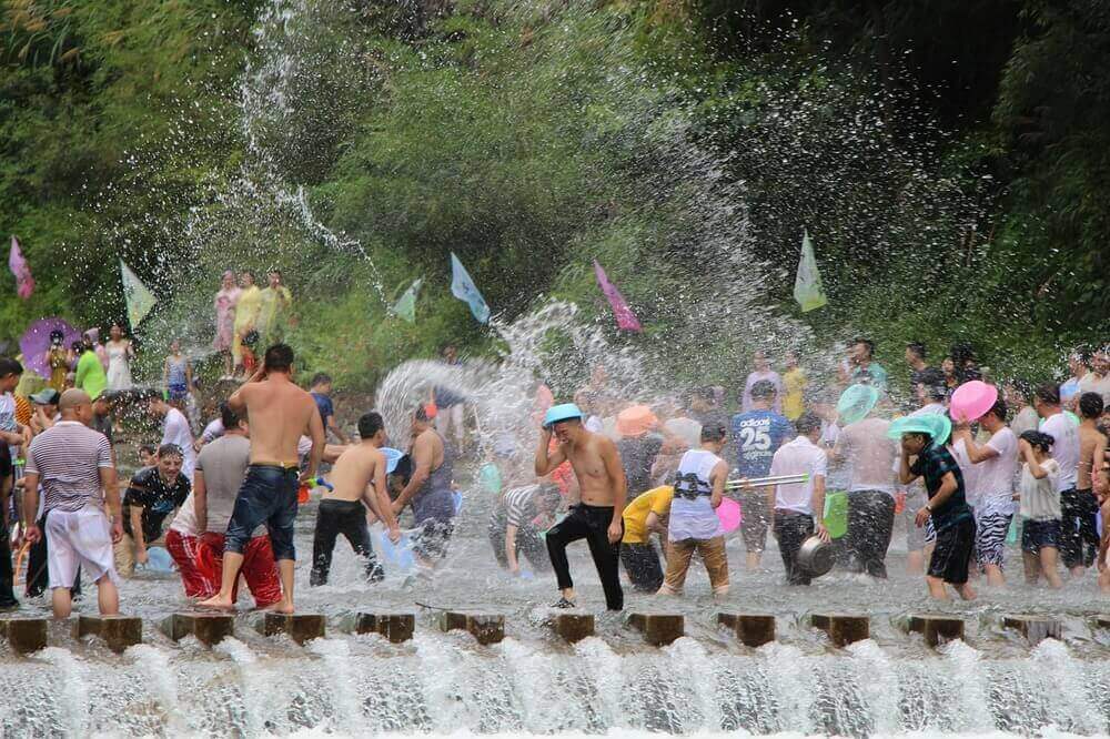 thai people throwing water for songkran thai new year