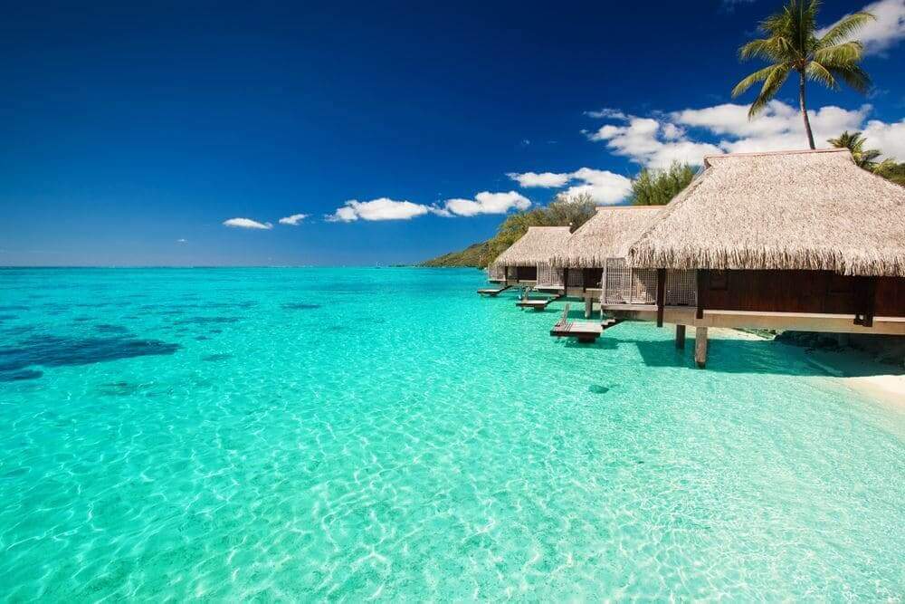 Water villas on a tropical beach island in the Maldives