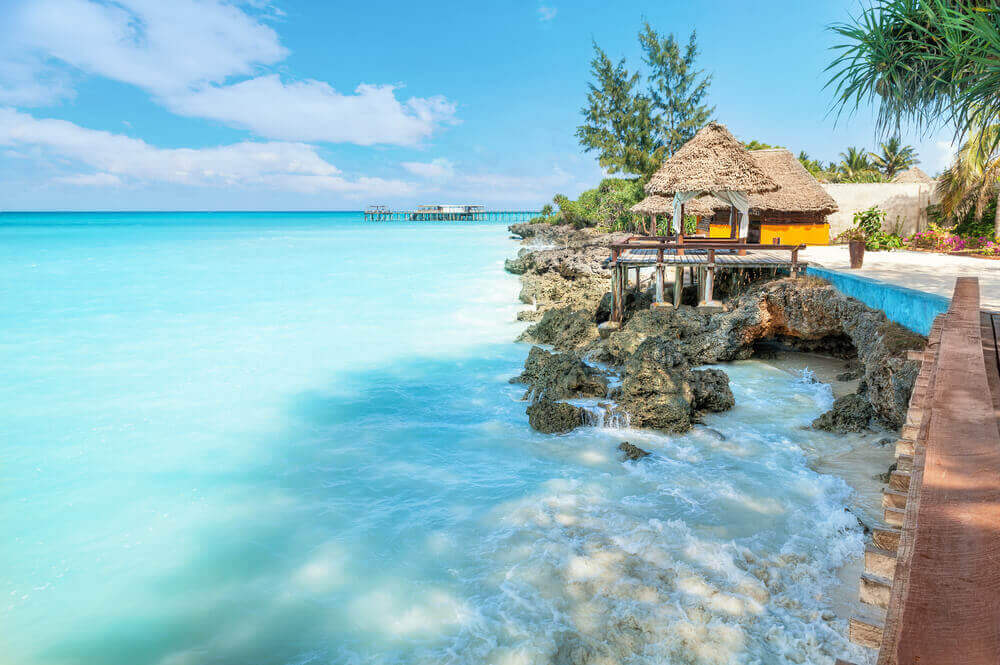 bungalows overlooking crystal blue water in zanzibar