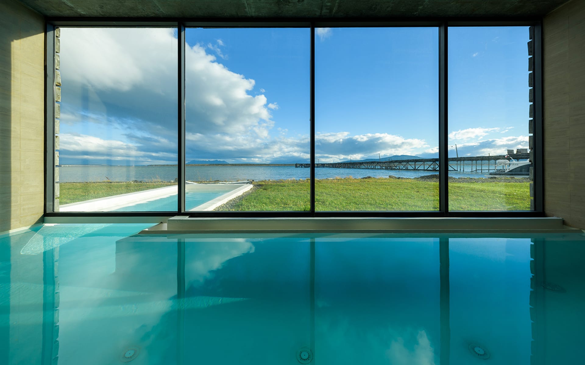 An infinity pool looks out of floor-to-ceiling windows at The Singular Patagonia.