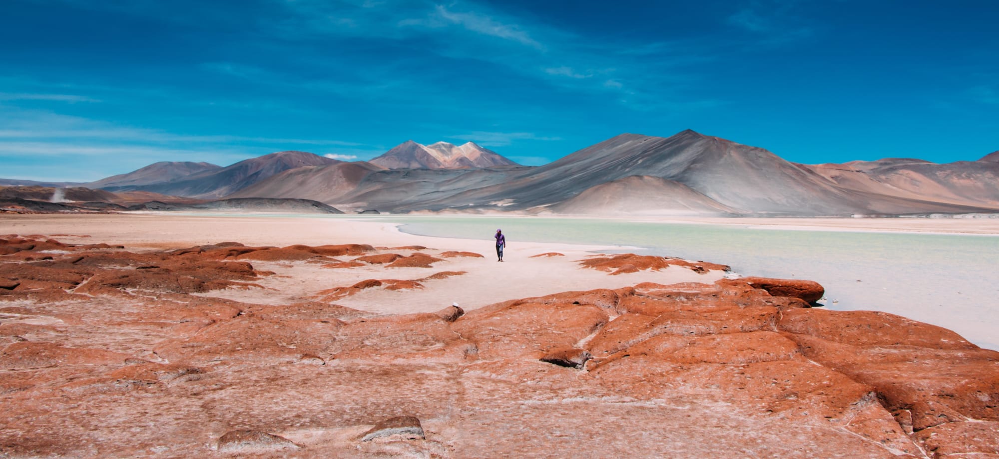 A man is walking in the Atacama Desert in Chile.